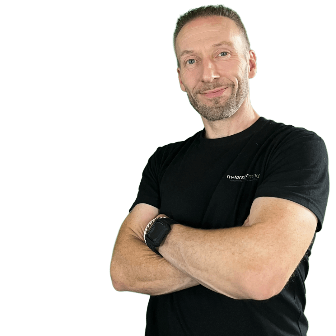 A man in a black shirt with his arms crossed.